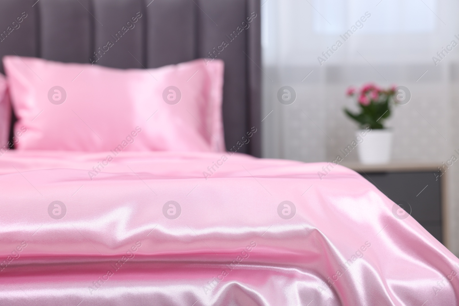 Luxury silk linens on bed at home, closeup Photo of Luxury silk linens on bed at home, closeup