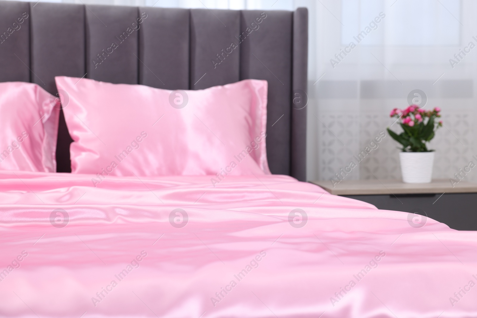Luxury silk linens on bed at home, closeup Photo of Luxury silk linens on bed at home, closeup