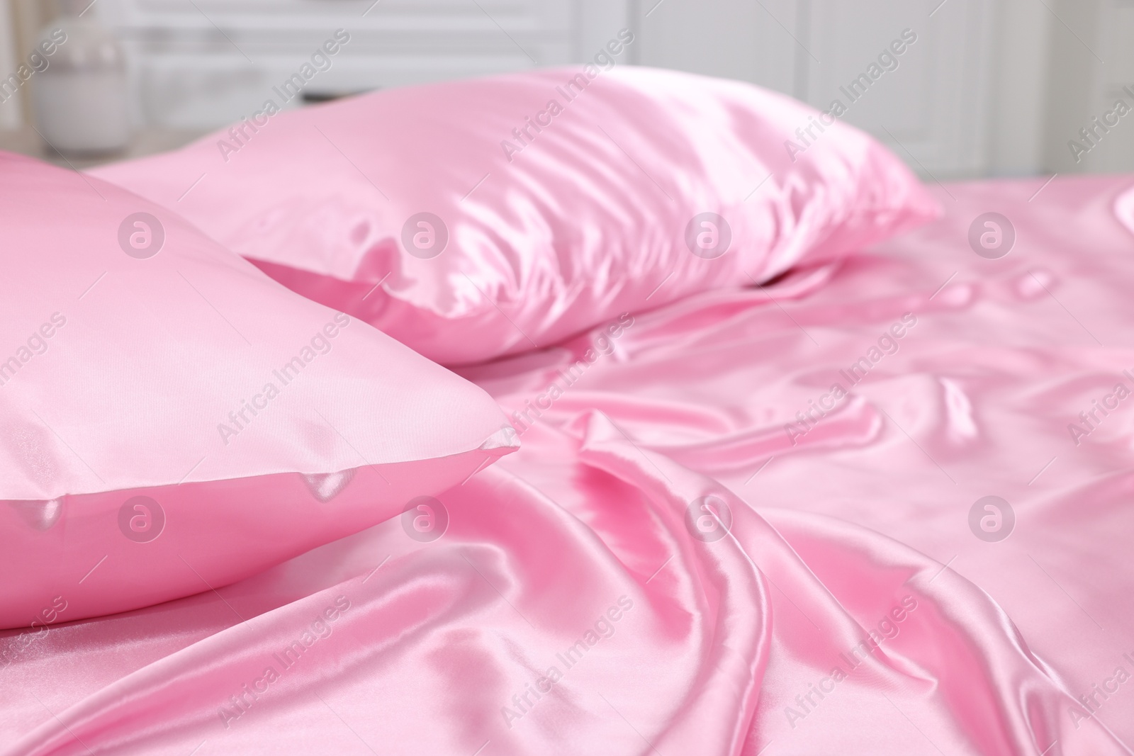 Luxury silk linens on bed at home, closeup Photo of Luxury silk linens on bed at home, closeup