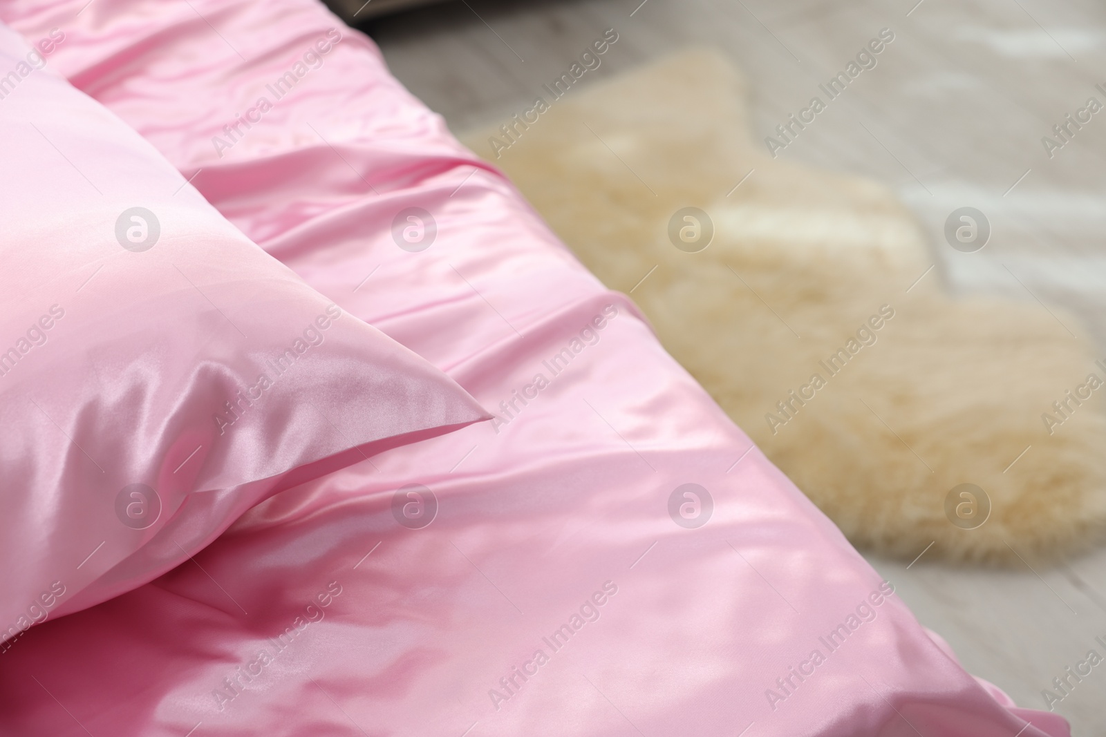 Luxury silk linens on bed at home, closeup Photo of Luxury silk linens on bed at home, closeup