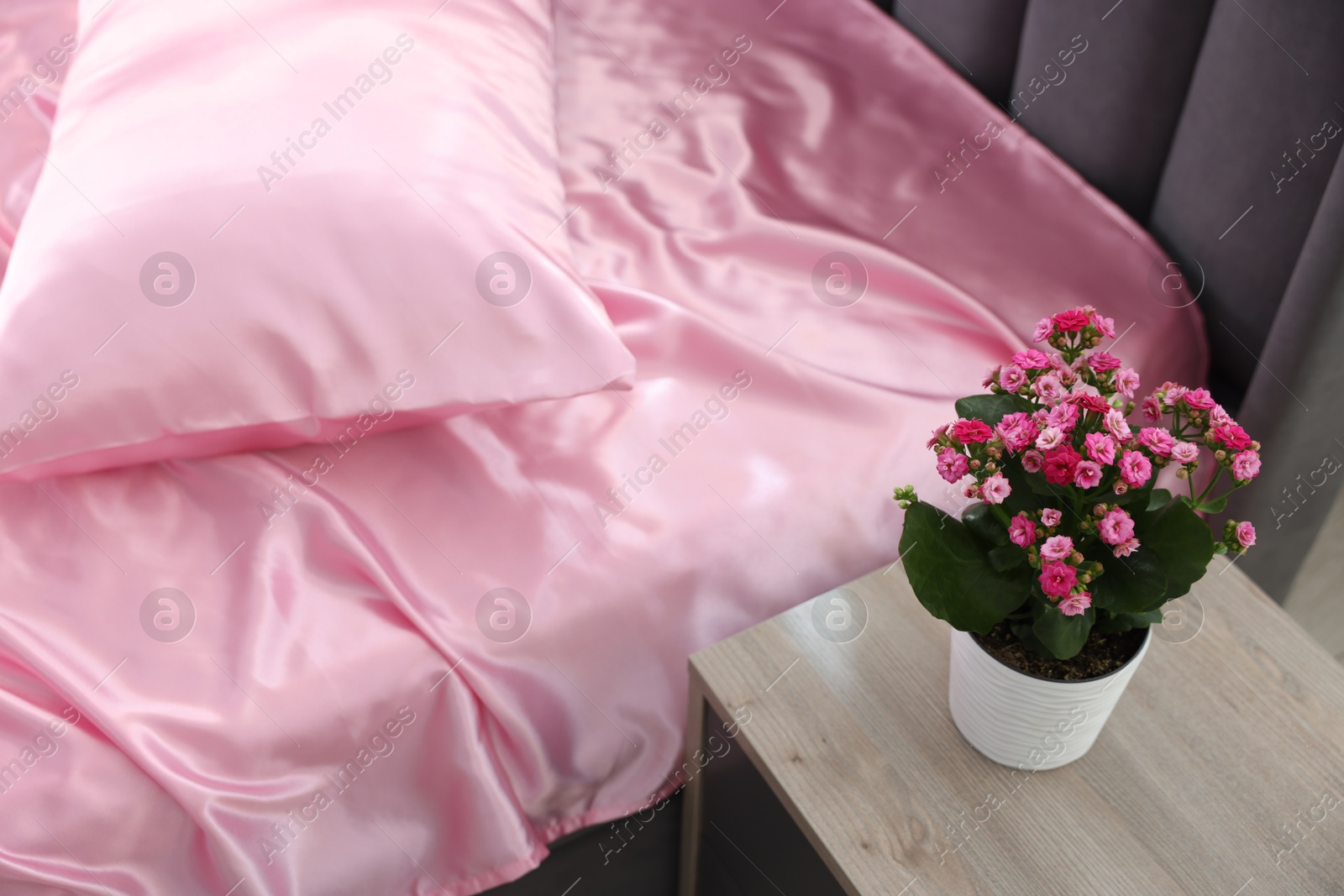 Luxury silk linens on bed at home Photo of Luxury silk linens on bed at home