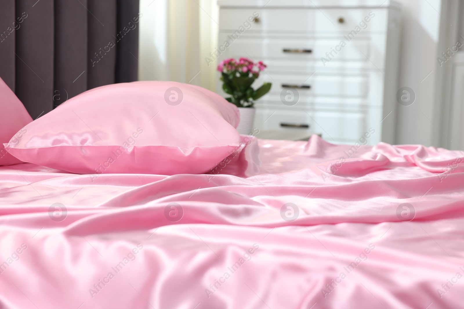 Luxury silk linens on bed at home, closeup Photo of Luxury silk linens on bed at home, closeup