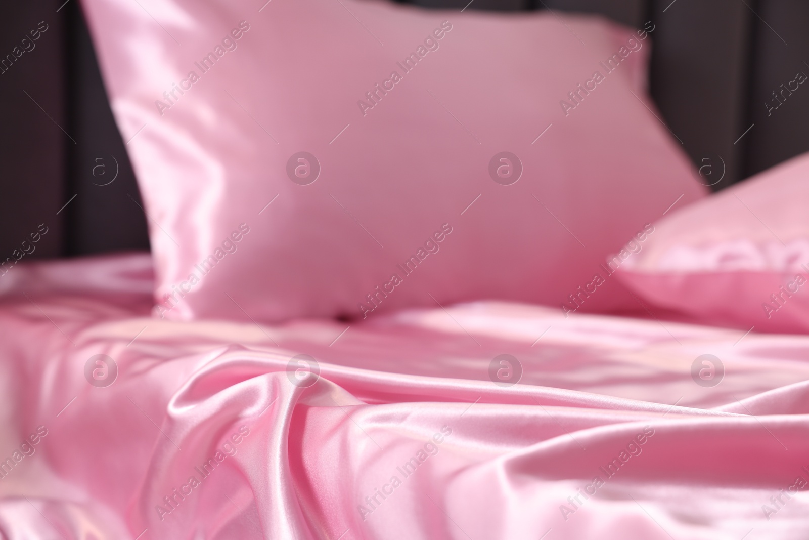 Luxury pink silk linens on bed, closeup Photo of Luxury pink silk linens on bed, closeup