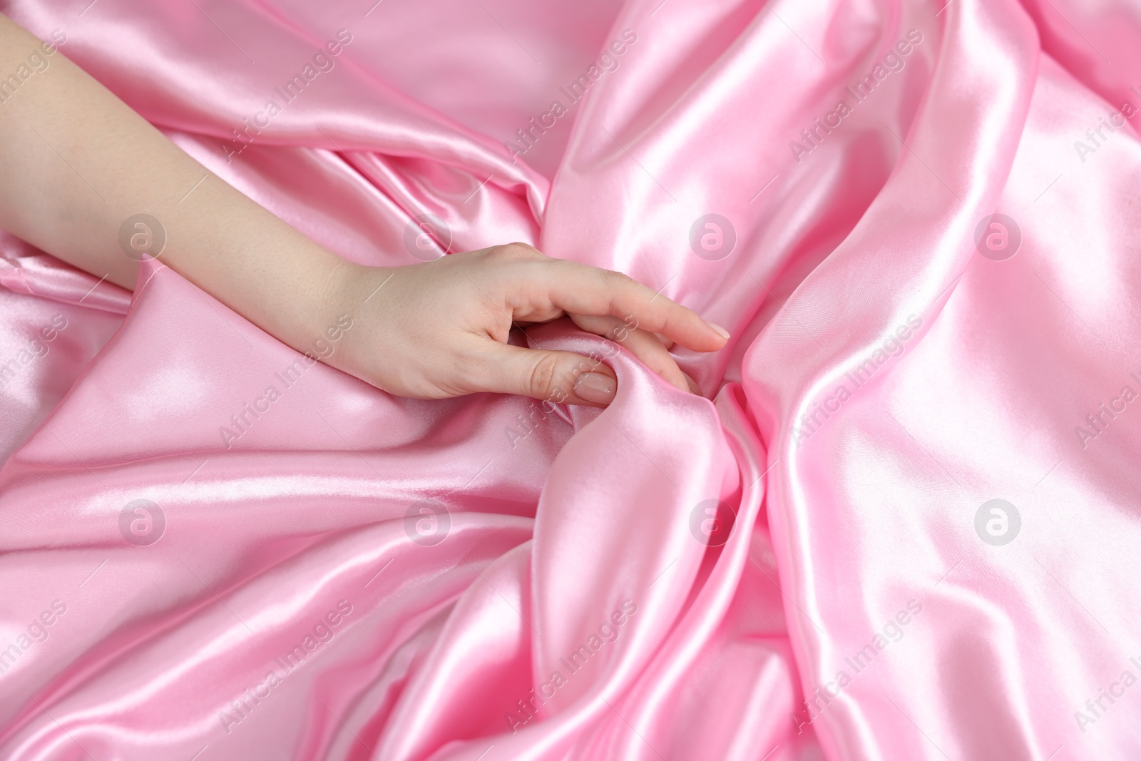 Woman with silk bed linens, above view Photo of Woman with silk bed linens, above view