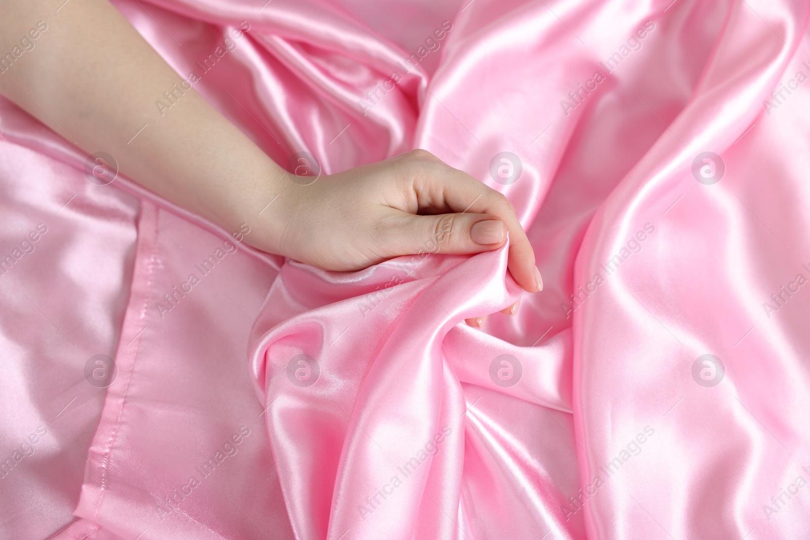 Woman with silk bed linens, above view Photo of Woman with silk bed linens, above view