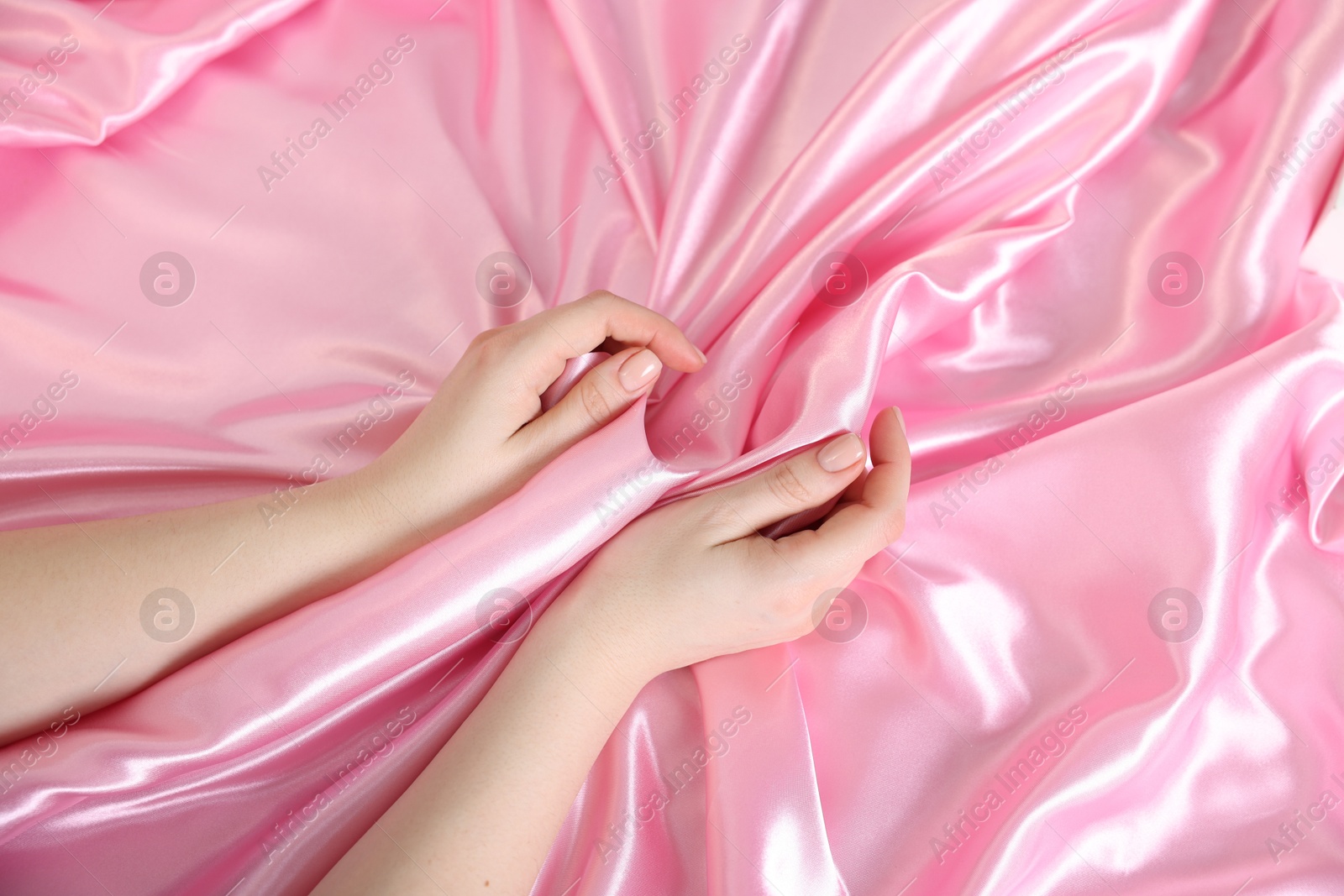 Woman with silk bed linens, top view Photo of Woman with silk bed linens, top view