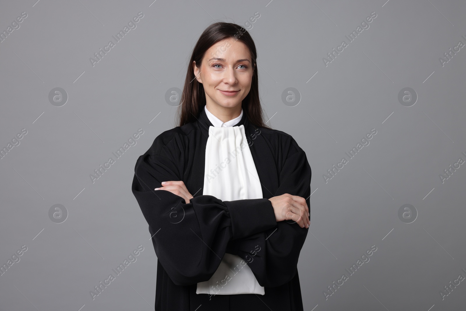 Portrait of judge in gown on gray background Photo of Portrait of judge in gown on gray background