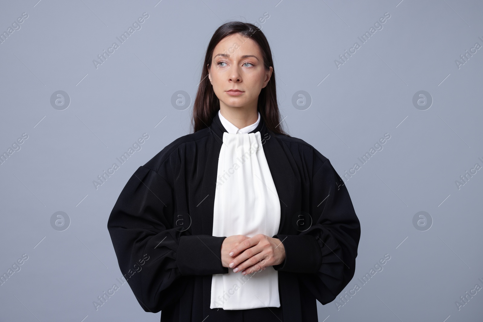 Portrait of judge in gown on gray background Photo of Portrait of judge in gown on gray background