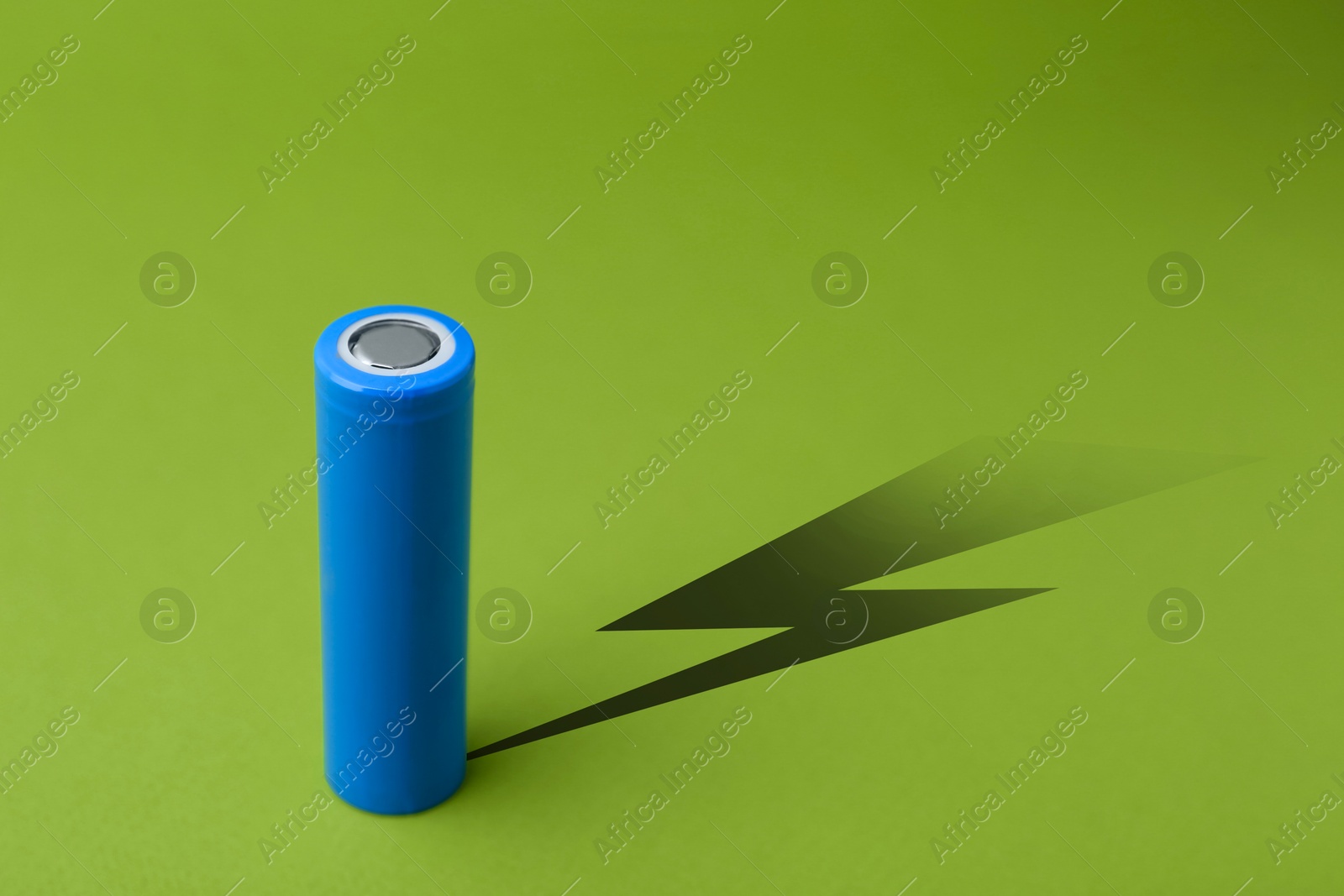 Alkaline battery with shadow in shape of lightning on green background Illustration of Alkaline battery with shadow in shape of lightning on green background