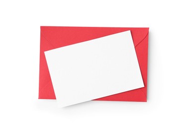 Photo of Blank greeting card and red paper envelope on white background, top view