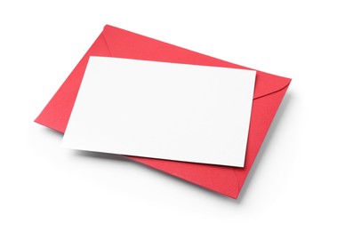 Photo of Blank greeting card and red paper envelope on white background, above view
