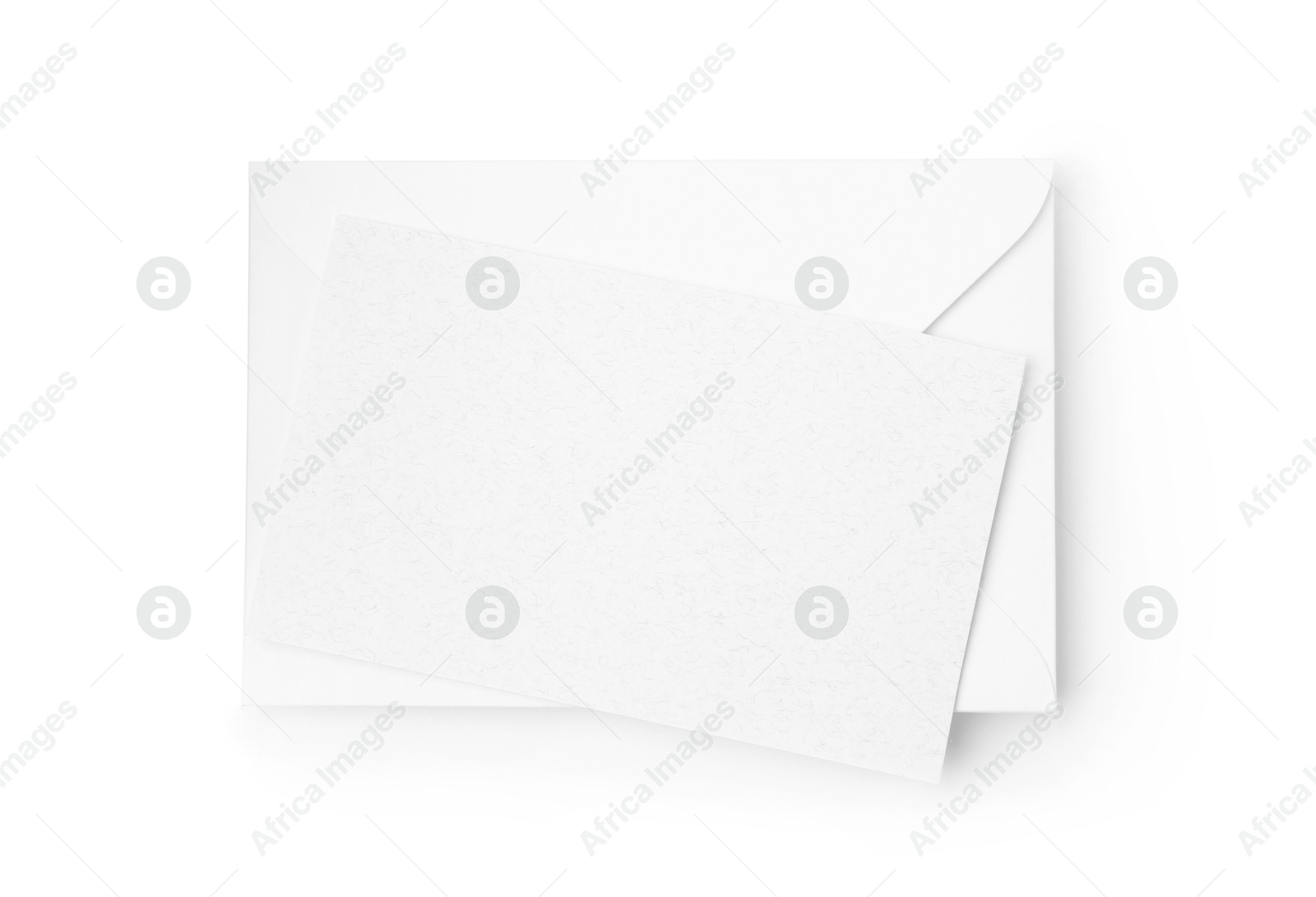Photo of Blank greeting card and paper envelope on white background, top view