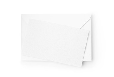 Photo of Blank greeting card and paper envelope on white background, top view