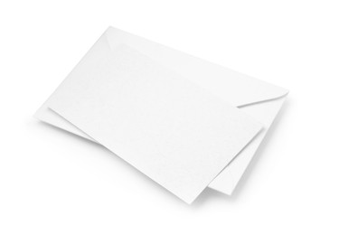 Photo of Blank greeting card and paper envelope on white background, above view