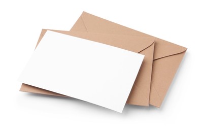 Photo of Blank greeting card and paper envelopes on white background, above view