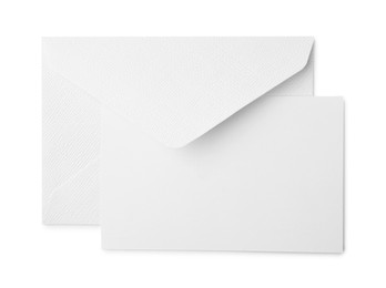 Photo of Blank greeting card and paper envelope on white background, top view