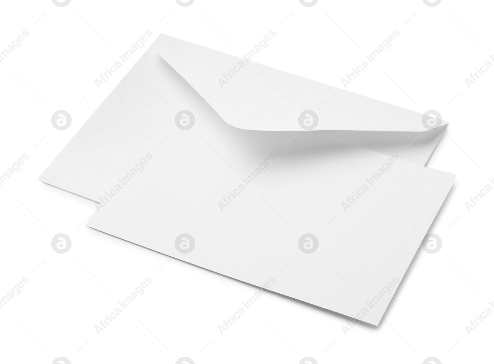 Photo of Blank greeting card and paper envelope on white background