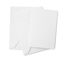 Photo of Blank greeting card and paper envelopes on white background, top view