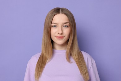 Photo of Portrait of beautiful teenage girl on violet background