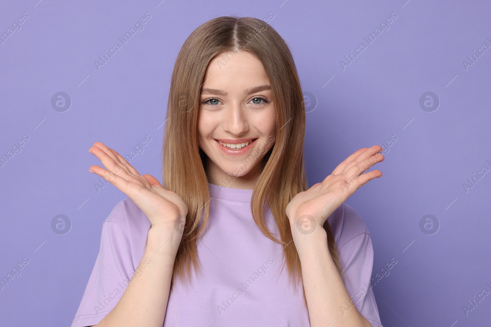 Portrait of smiling teenage girl on violet background Photo of Portrait of smiling teenage girl on violet background
