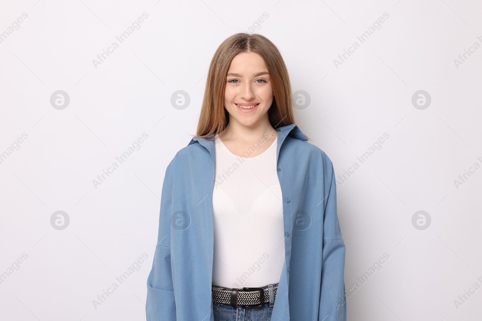 Portrait of smiling teenage girl on white background Photo of Portrait of smiling teenage girl on white background