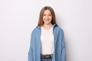 Photo of Portrait of smiling teenage girl on white background