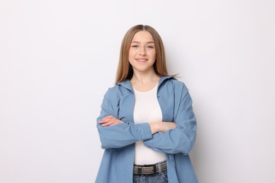 Photo of Portrait of smiling teenage girl on white background