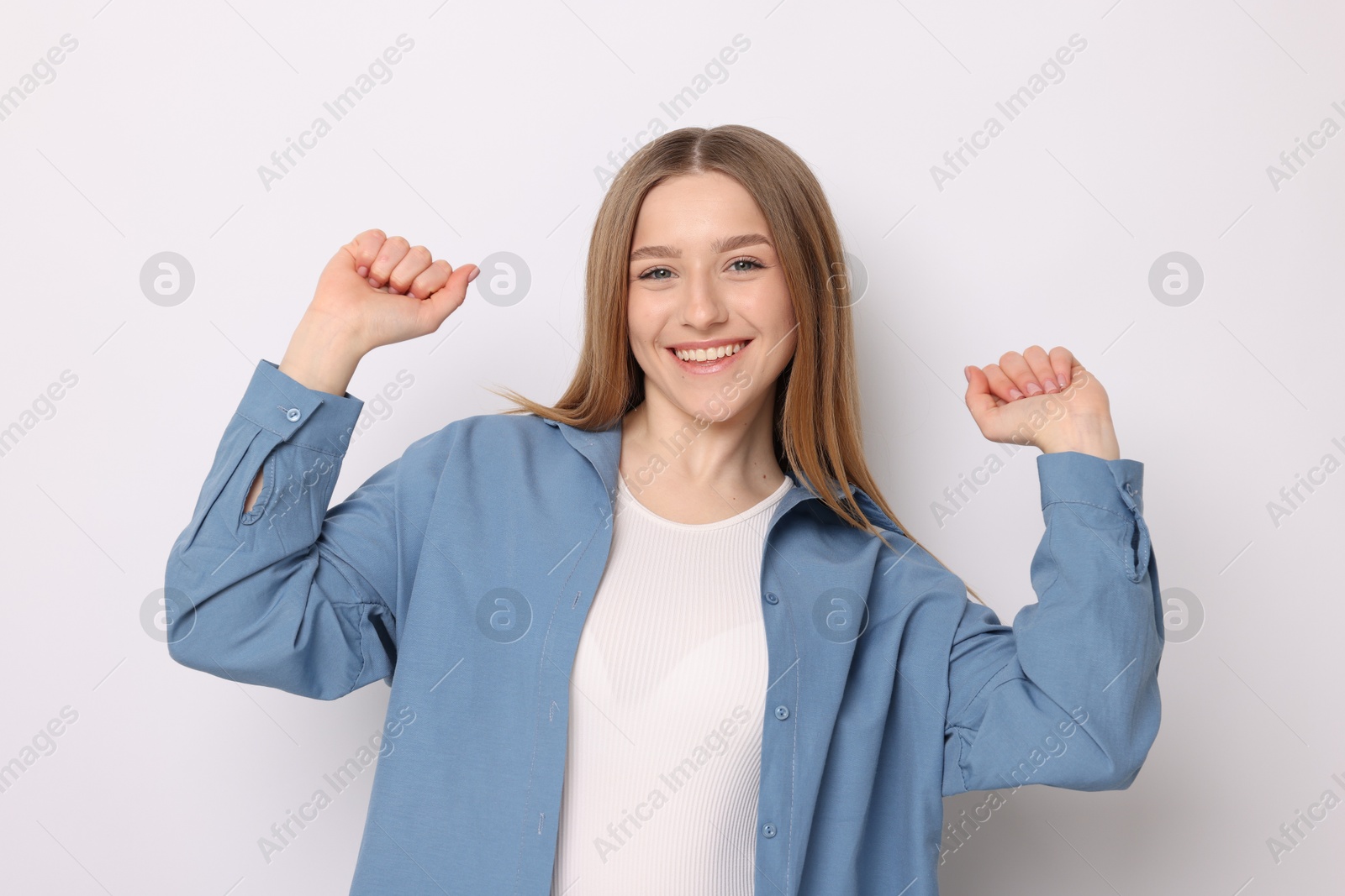 Portrait of smiling teenage girl on white background Photo of Portrait of smiling teenage girl on white background