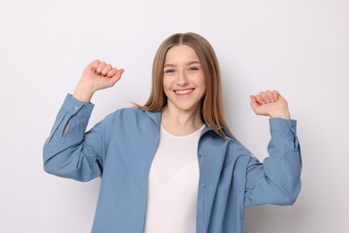 Photo of Portrait of smiling teenage girl on white background