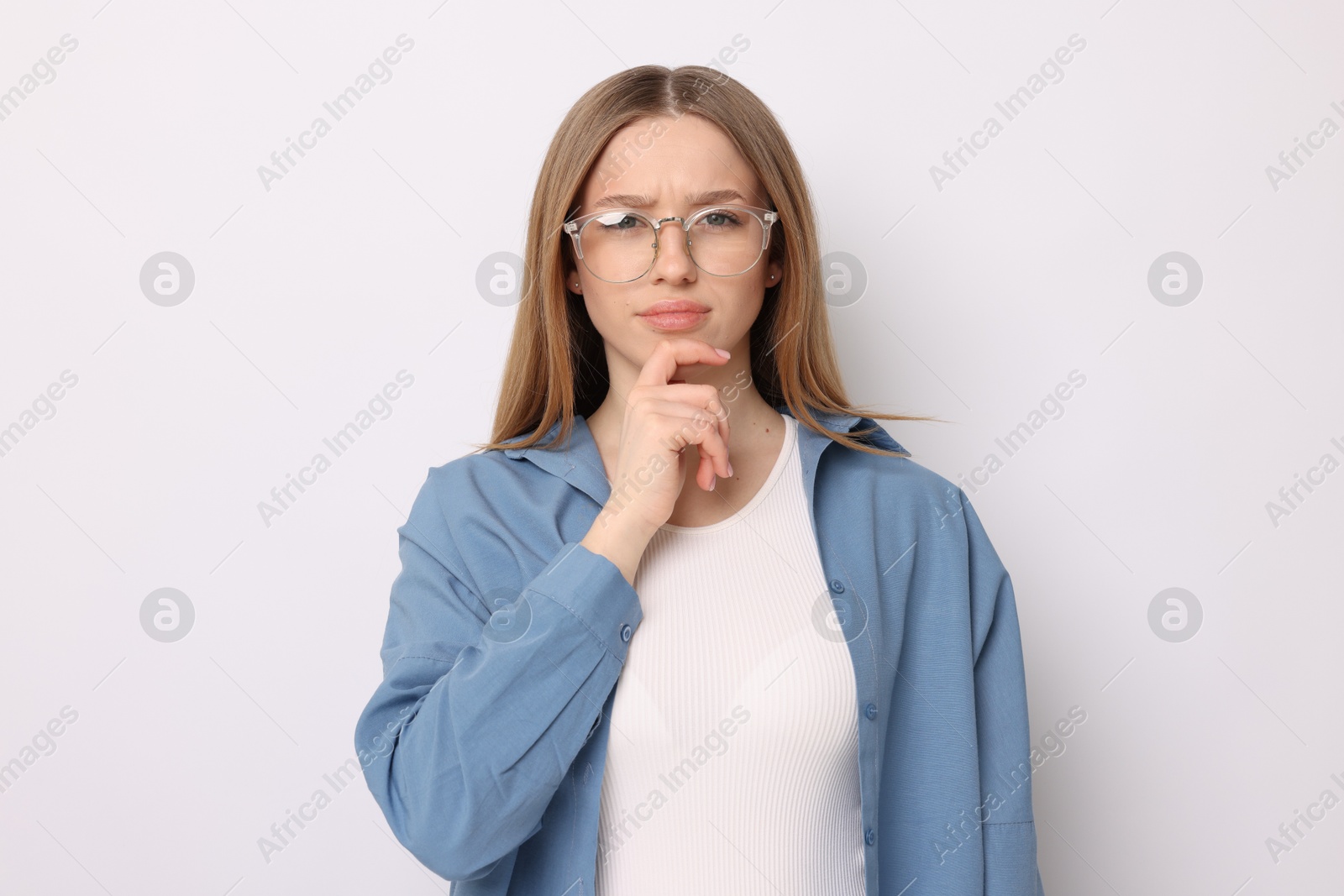 Portrait of thoughtful teenage girl on white background Photo of Portrait of thoughtful teenage girl on white background