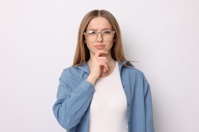 Photo of Portrait of thoughtful teenage girl on white background