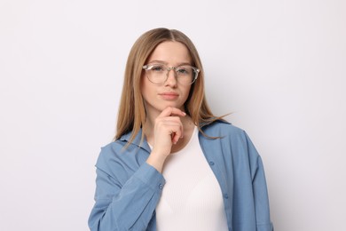 Photo of Portrait of thoughtful teenage girl on white background