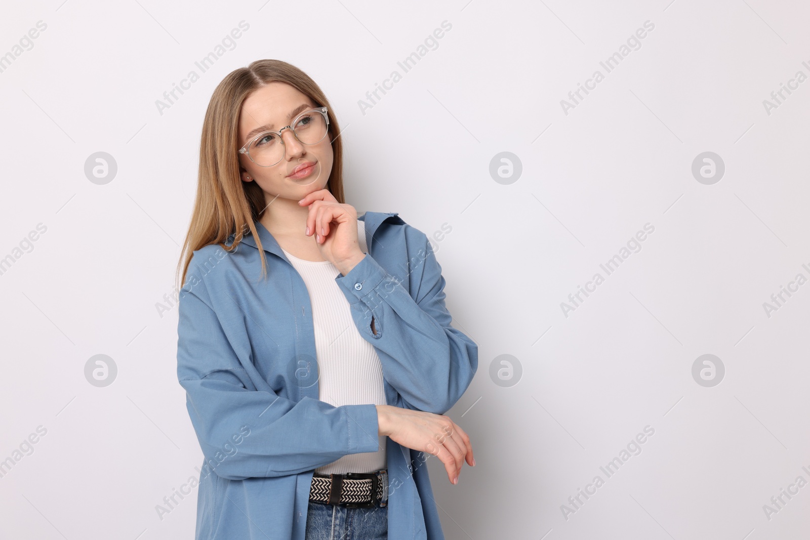 Photo of Thoughtful teenage girl on white background. Space for text