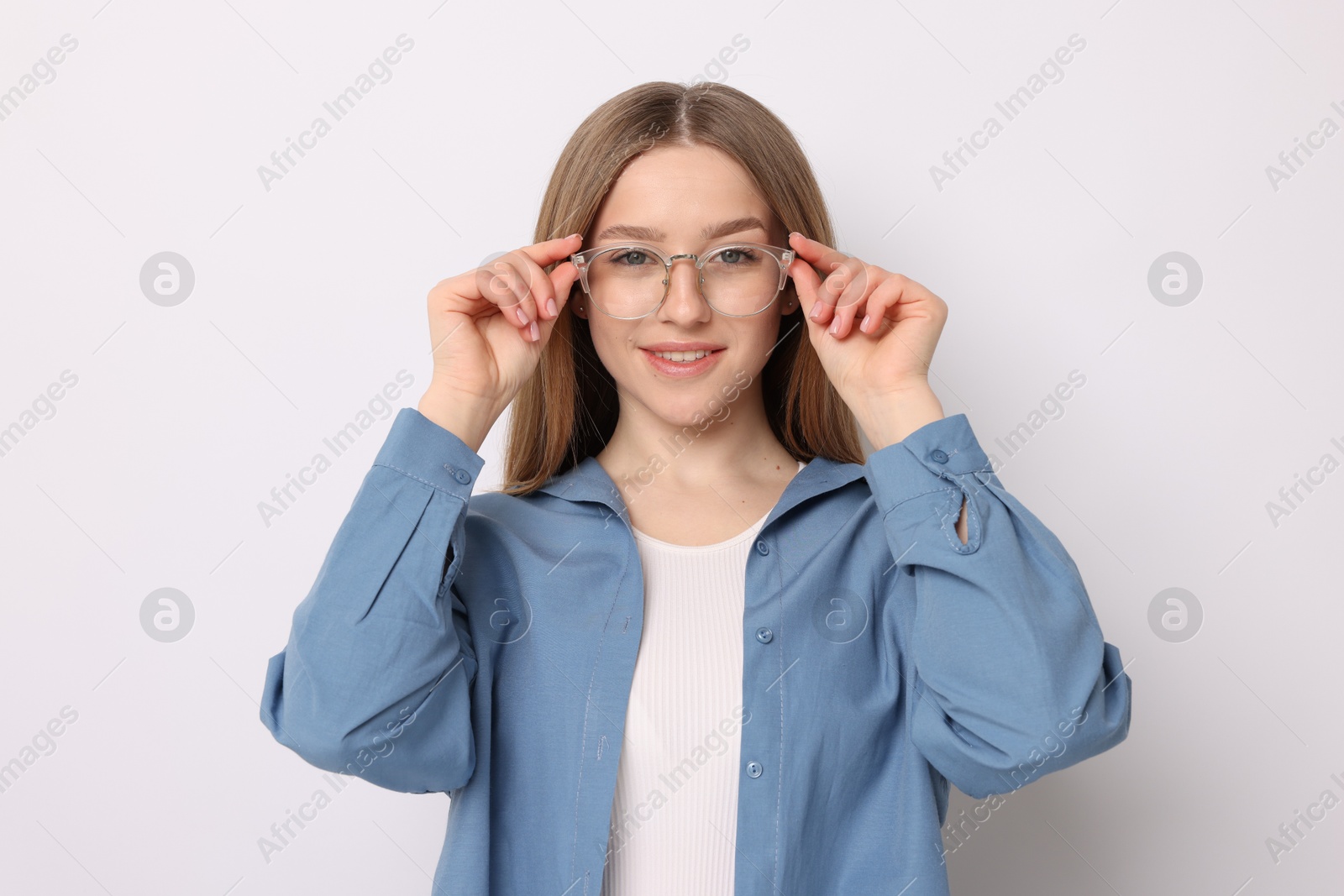 Portrait of smiling teenage girl on white background Photo of Portrait of smiling teenage girl on white background