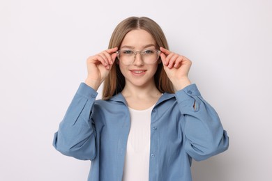 Photo of Portrait of smiling teenage girl on white background