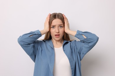 Photo of Portrait of emotional teenage girl on white background