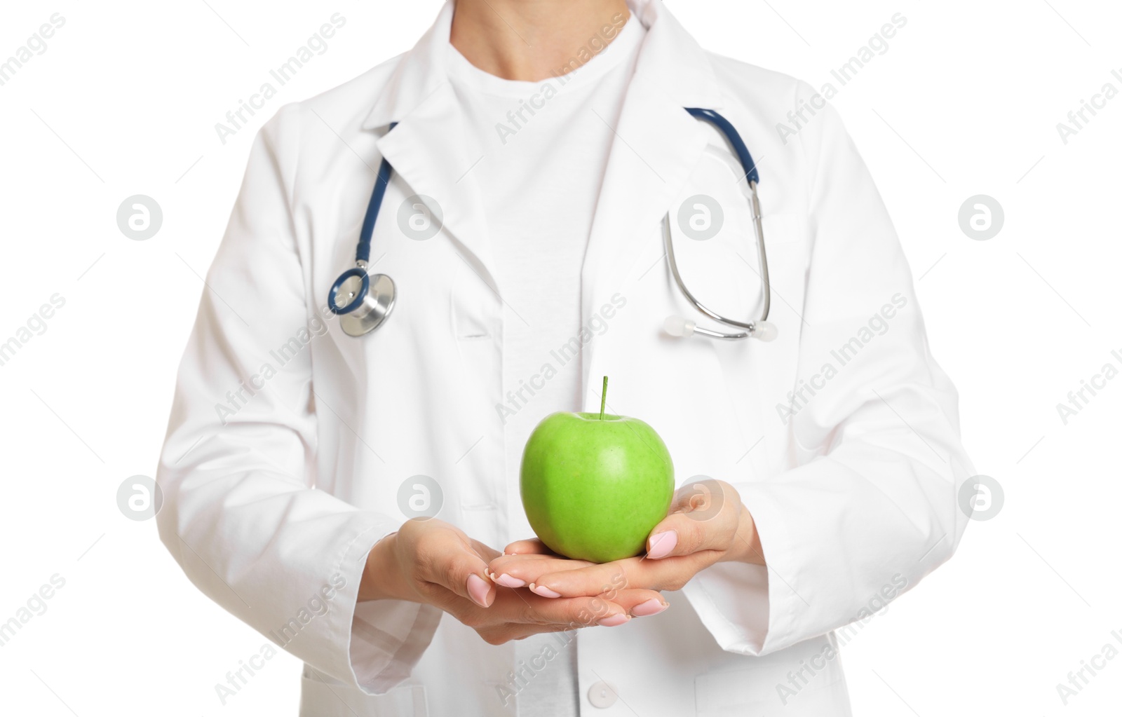 Photo of Nutritionist with green apple and stethoscope on white background, closeup
