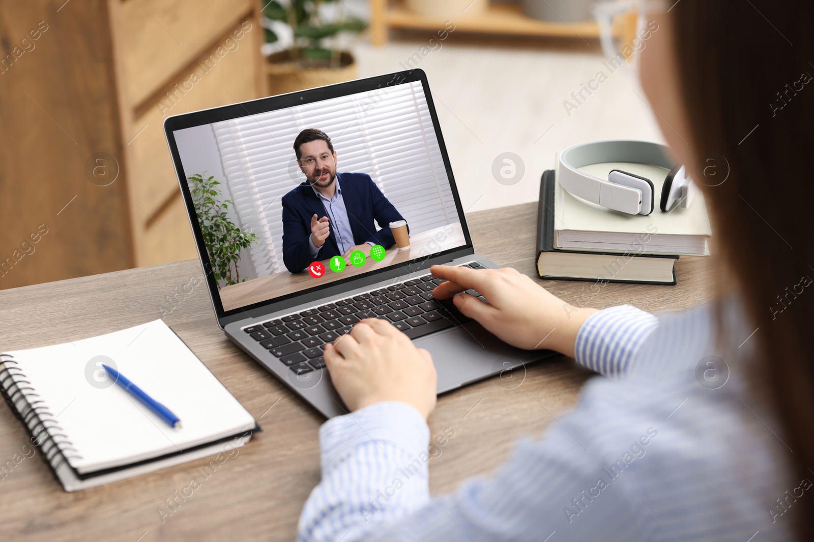 Woman listening to speaker via laptop online at table, closeup Image of Woman listening to speaker via laptop online at table, closeup