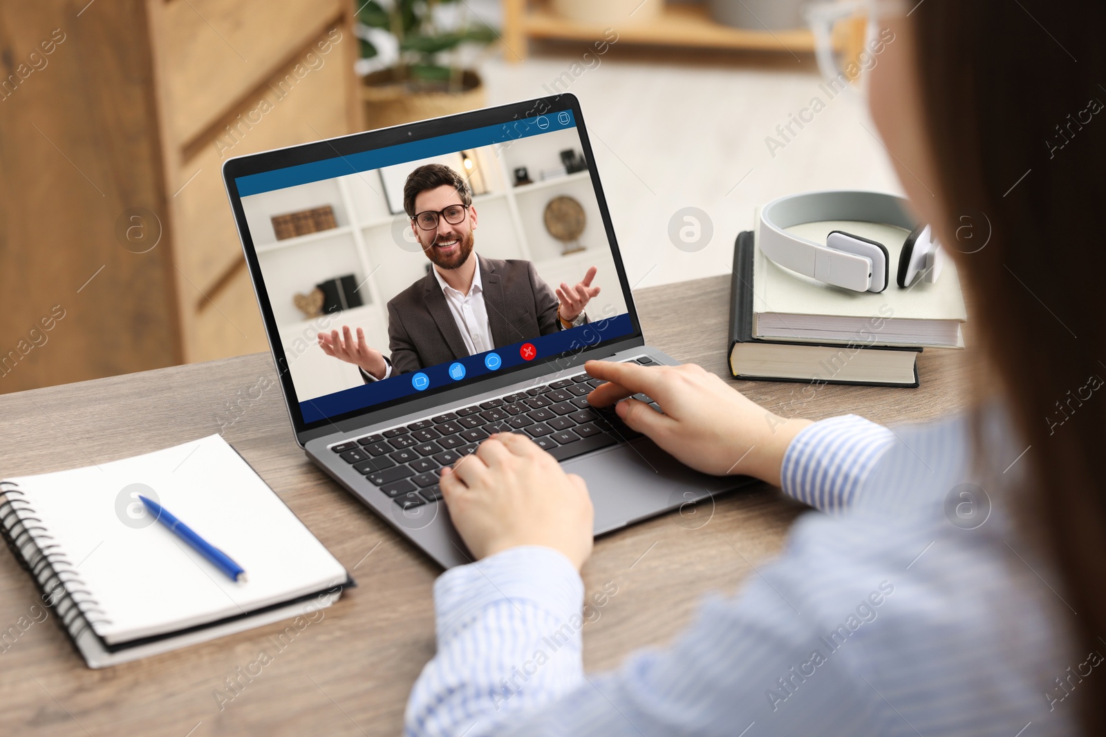 Woman listening to speaker via laptop online at table, closeup Image of Woman listening to speaker via laptop online at table, closeup
