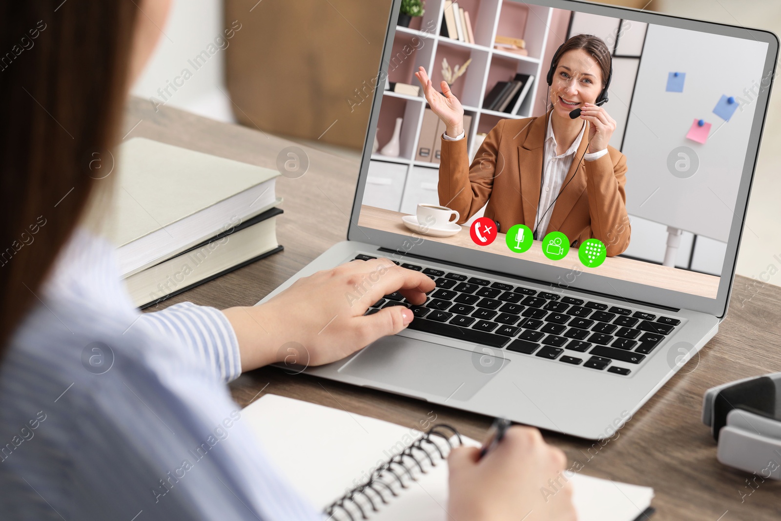 Woman listening to speaker via laptop online at table, closeup Image of Woman listening to speaker via laptop online at table, closeup