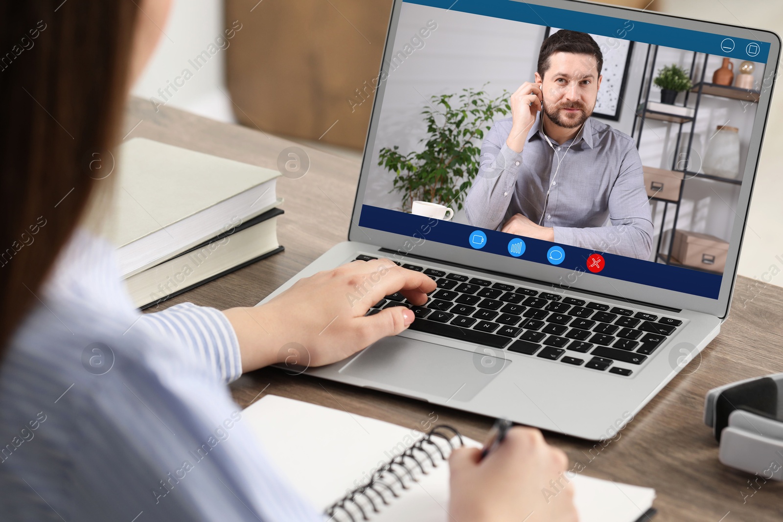 Woman listening to speaker via laptop online at table, closeup Image of Woman listening to speaker via laptop online at table, closeup