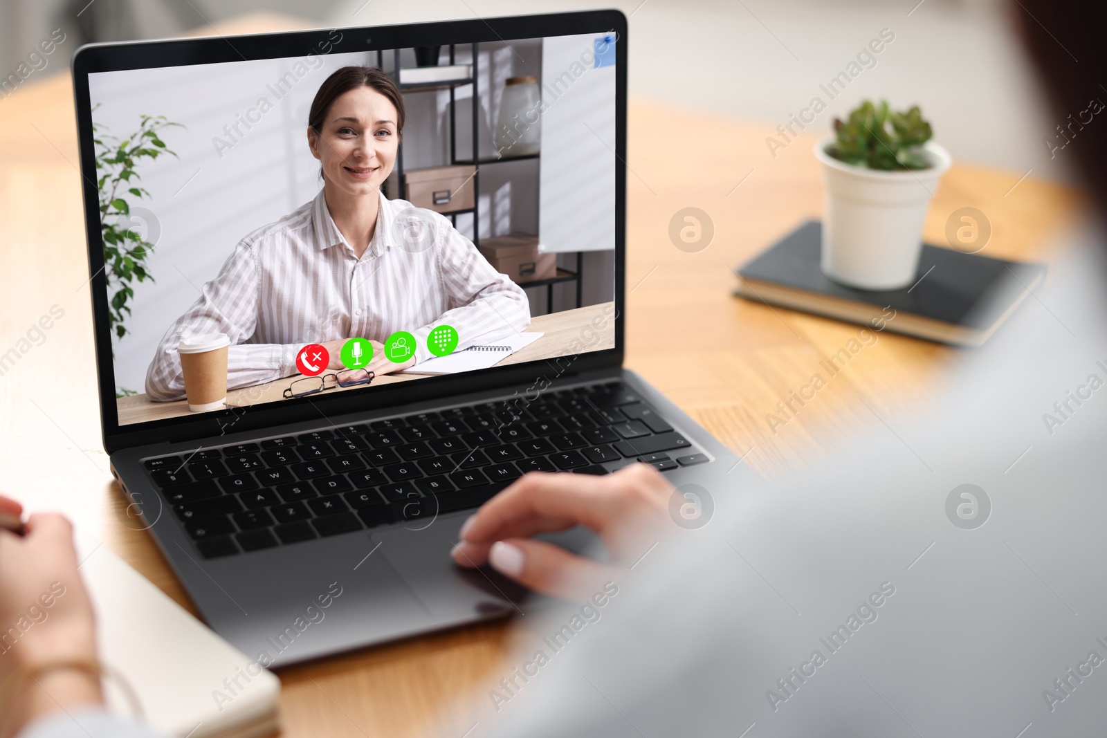 Woman listening to speaker via laptop online at table, closeup Image of Woman listening to speaker via laptop online at table, closeup