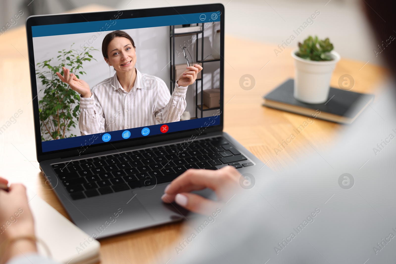 Woman listening to speaker via laptop online at table, closeup Image of Woman listening to speaker via laptop online at table, closeup