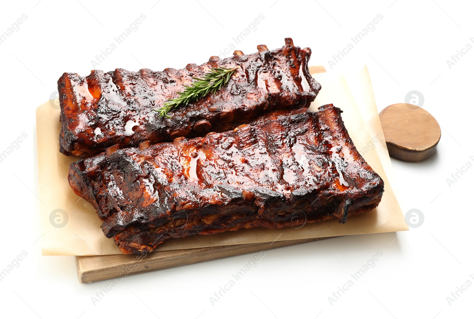 Tasty roasted pork ribs and rosemary isolated on white Photo of Tasty roasted pork ribs and rosemary isolated on white