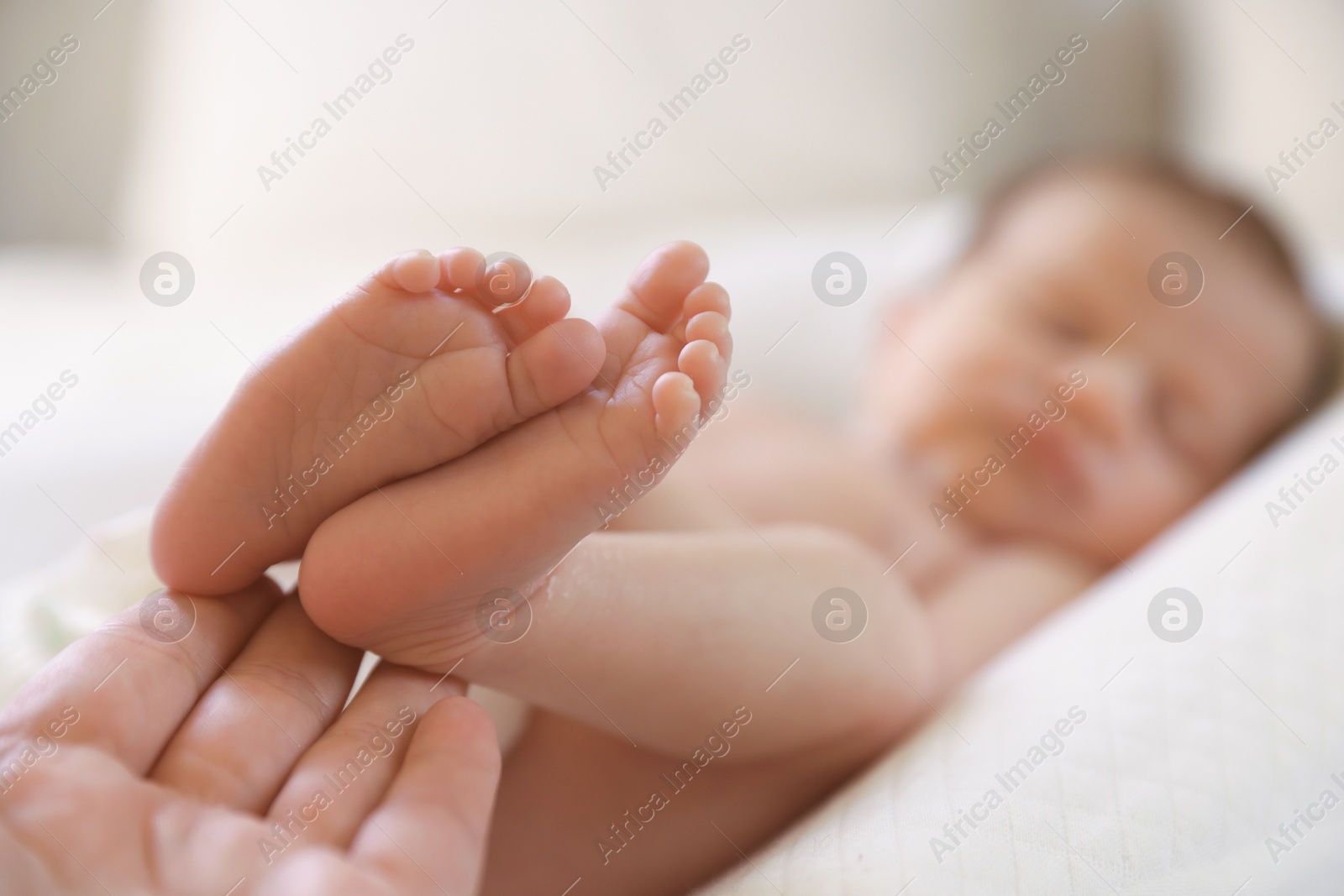 Mother with her little baby on bed indoors, closeup Photo of Mother with her little baby on bed indoors, closeup