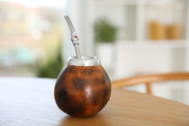 Photo of Traditional yerba mate tea on wooden table indoors