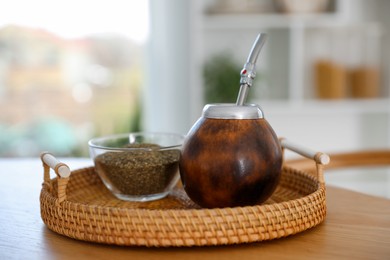 Photo of Traditional yerba mate tea on wooden table indoors