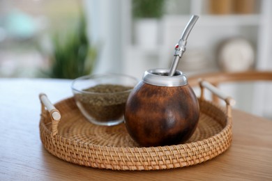 Photo of Traditional yerba mate tea on wooden table indoors, closeup