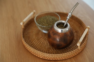 Photo of Traditional yerba mate tea on wooden table, closeup