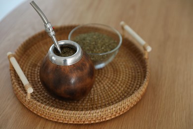 Photo of Traditional yerba mate tea on wooden table, closeup
